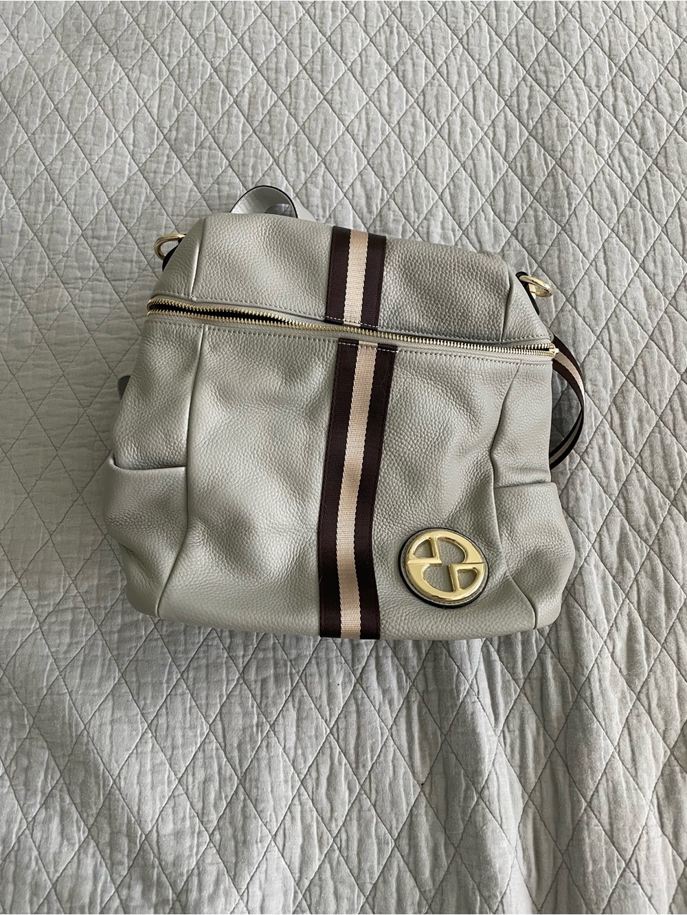 Gray Pebble Leather Backpack with Brown Stripe and Gold Emblem